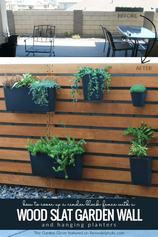 How to cover up a cinder block fence with a wood slat garden wall with vertical hanging planters, The Garden Glove featured on Remodelaholic.com